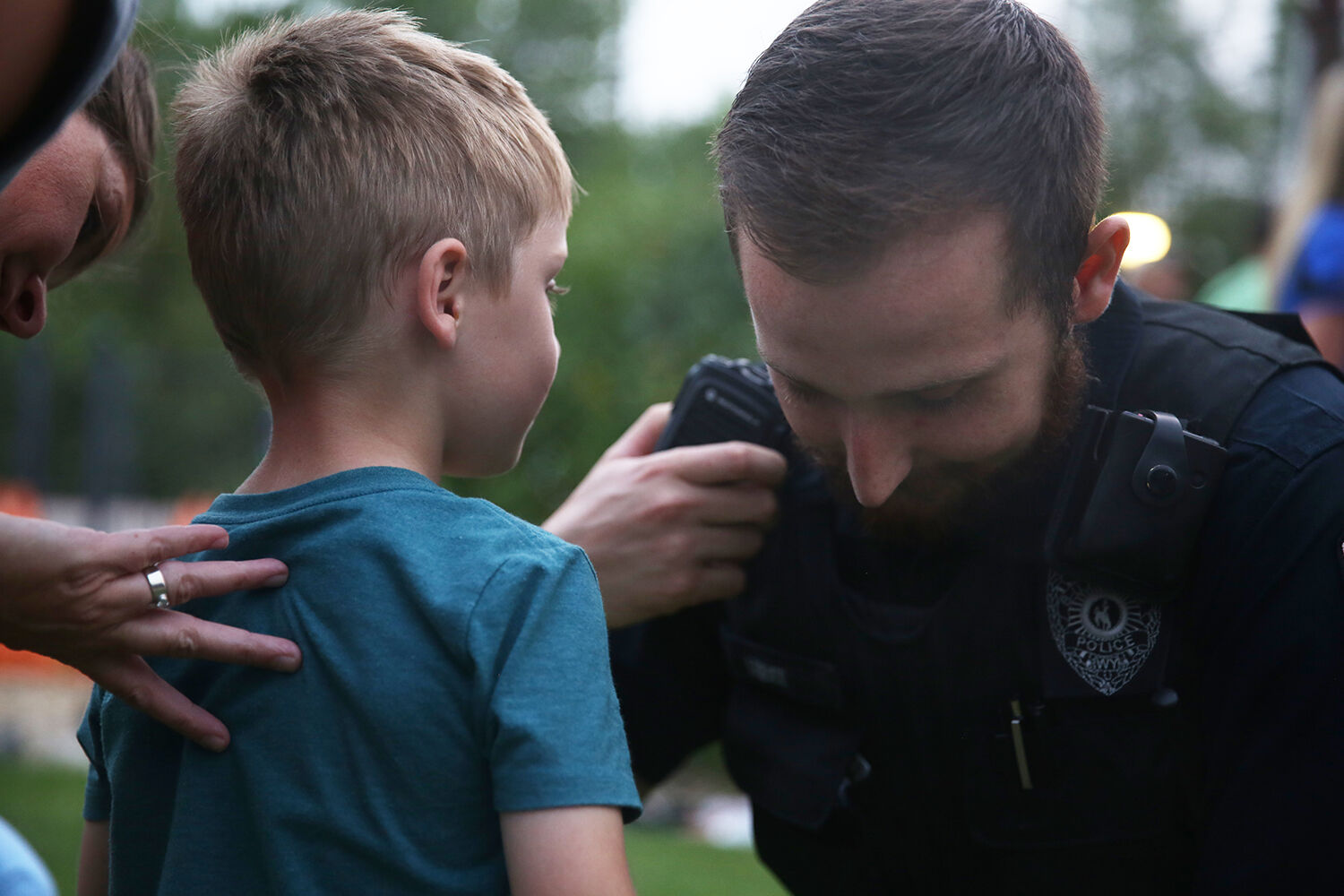 Officer Tucker Leibee shows a boy his radio